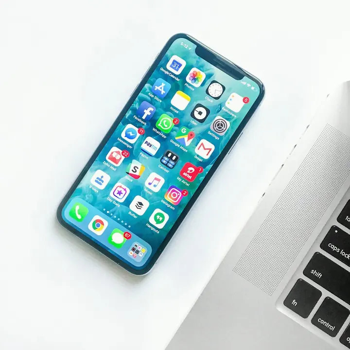 A hand holding a smartphone.